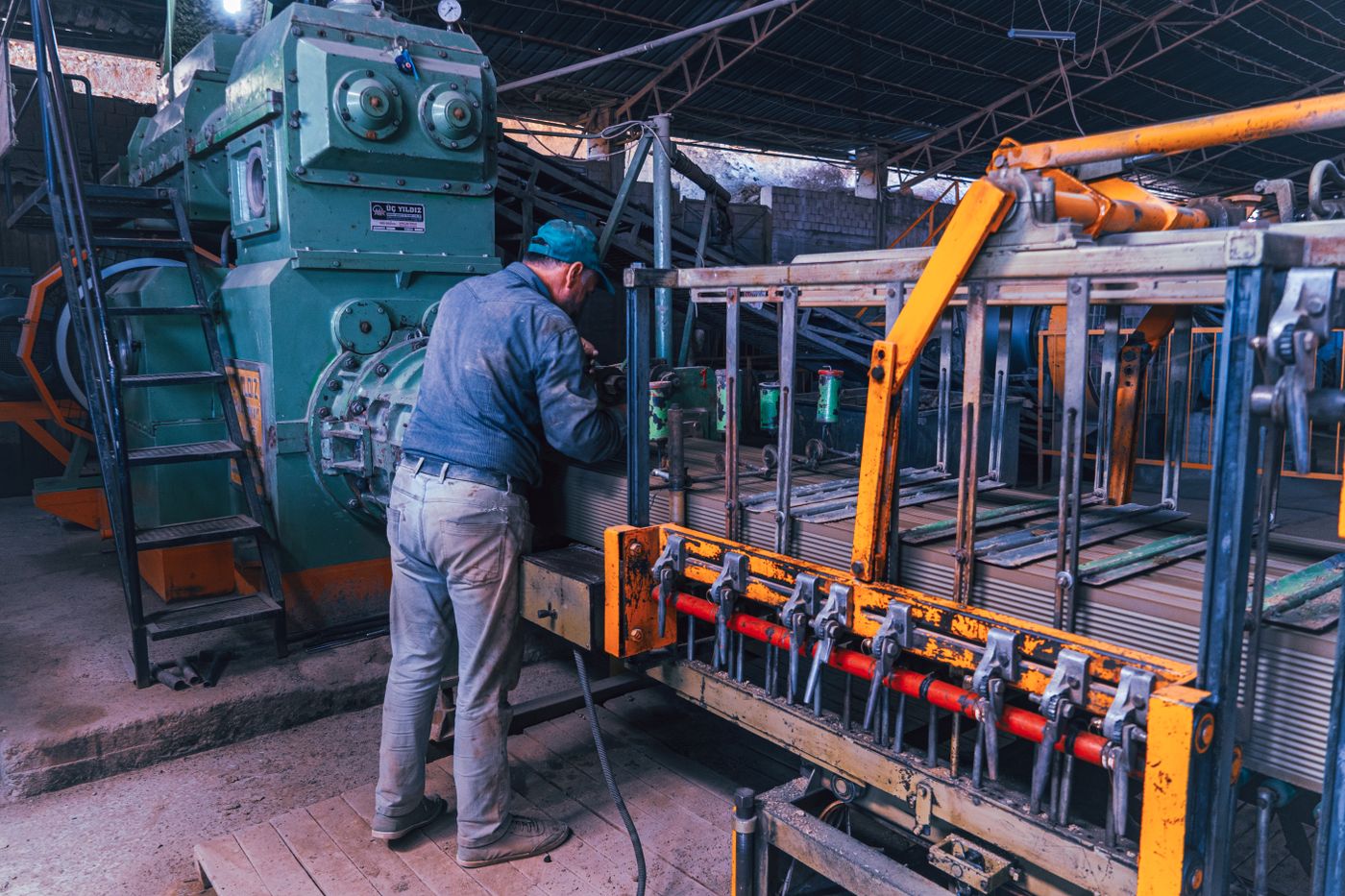 Factory worker operating industrial machinery.
